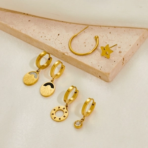 Detailed set of gold titanium steel earrings with moon, star, and butterfly charms