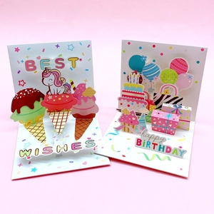 3D pop-up birthday greeting cards with unicorn and cake designs on pink background