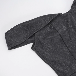 Detailed close-up of dark grey shimmering fabric on an off-shoulder evening dress