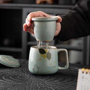 Celadon ceramic tea mug with ice crackle glaze and hand-painted jade rabbit design