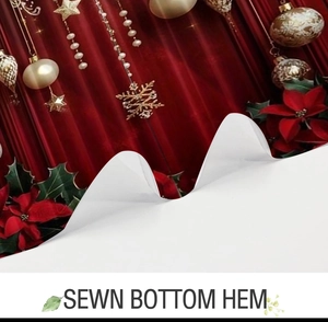 Detail showing the sewn bottom hem of a Christmas shower curtain with floral printing