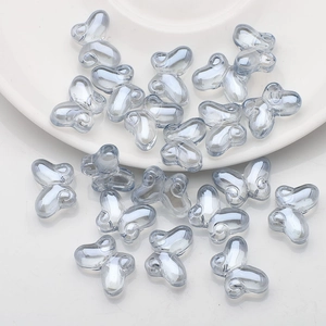 Macro shot of 10x14mm translucent grey-blue butterfly glass beads for DIY jewelry making