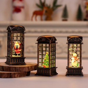 Detail of vintage bronze Christmas phone booth lantern with Santa and glowing water globe