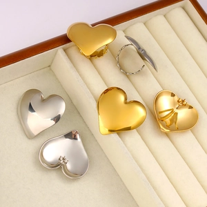 Stainless steel heart earring and ring set in 18K gold and silver finish on display