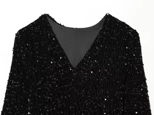Macro view of high-quality black sequins on the collar of a chic evening mini dress