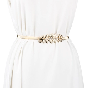 Close-up of a gold metal elastic waist belt with leaf design on a white dress