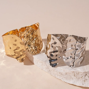 Minimalist textured open cuff bracelets in gold and silver finish on stone base
