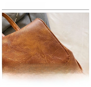 Close-up of premium dark brown leather material with a natural lychee texture detail