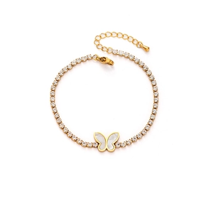 Detailed macro of gold butterfly charm with zircon stone settings on titanium bracelet