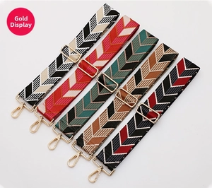 Close-up of five colorful ethnic woven shoulder straps with golden metal buckles