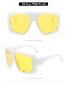 Detail view of oversized white jelly frames with yellow lenses and integrated nose pads