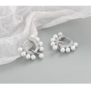 Detailed shot of S925 sterling silver hoop earrings with white pearls and crystals