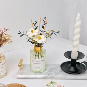120ml Reed Diffuser with green aromatherapy oil and dried flowers on marble tray
