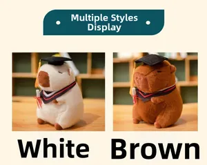 Close-up of white and brown capybara plush toys wearing graduation caps and academic gowns
