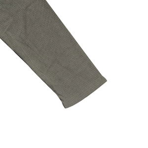 Macro detail of high-density ribbed knit cuffs on taupe slim fit henley shirt for men