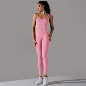 Detail of pink ribbed seamless yoga jumpsuit showing the U-neck and back design