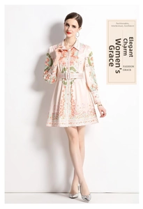 Detailed close-up of pink long-sleeve silk dress featuring vintage floral and marine prints