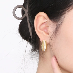 French vintage gold C-shape hoop earrings with twisted texture and pearl insets on ear