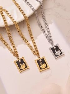 Macro view of vintage relief pendant necklaces with black enamel and pearl details