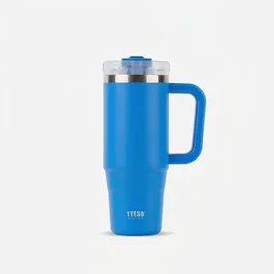 Detail view of a 40oz insulated stainless steel tumbler with handle and straw in bright blue