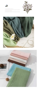 Detail of colorful cotton linen scarves with frayed edges and natural crinkle texture
