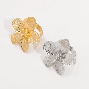 Detailed top view of gold and silver metallic flower rings with realistic petal texture