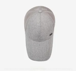 Top-down view of a grey trucker hat with mesh panels and a small metal side logo