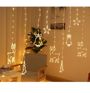Close-up of LED curtain lights with warm yellow stars, bells, and Christmas trees decor