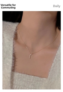 Macro view of gold moon pendant necklace with micro-pave diamonds on model