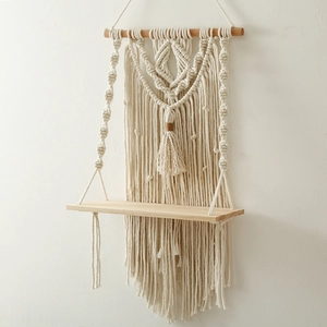 Close-up of hand-woven bohemian tapestry shelf showing detailed macrame cotton rope texture