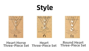 Detailed set of three heart and horse pendant necklaces on kraft paper display cards