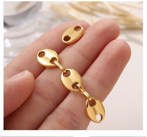 Macro detail of the golden geometric pig nose link chain for trendy earrings