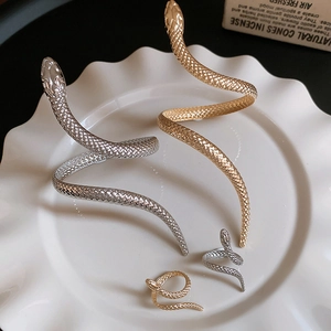 Detailed view of snake-shaped gold and silver jewelry set with realistic scale texture