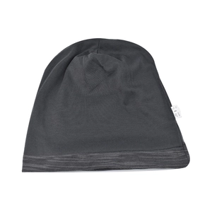 Detailed close-up of dark grey cotton knit beanie with texture and white product label