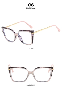 Detail view of pink tortoiseshell cat-eye glasses with gold metal temples, model C6