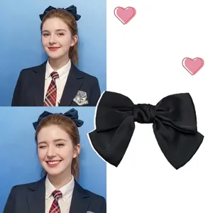 Detailed view of a large black satin bow hair clip for elegant princess hairstyles