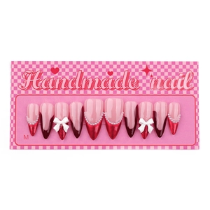 French red handmade press-on nails with 3D bows and pearls on a pink display card