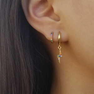 Detail of silver lightning bolt charm hoop earring with colorful pavé cubic zirconia