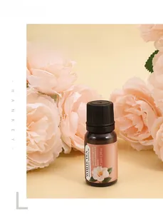 Huile essentielle de thé blanc en flacon de 10ml avec des roses roses pour aromathérapie