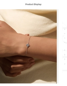 Detail of S925 sterling silver clover bracelet with sparkling moissanite on wrist