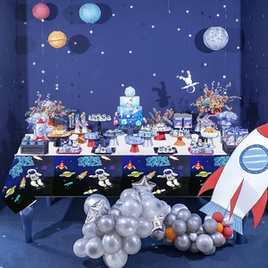 Space themed astronaut party tablecloth with rockets and planets for boy birthday decor