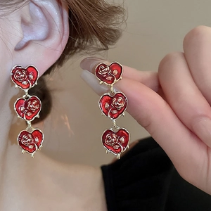 Vintage red heart earrings with golden embossed rose detail in French luxury style