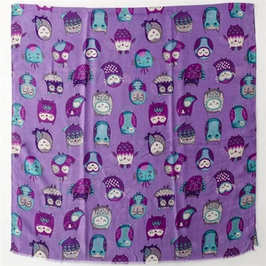 Detail of purple cotton linen feel scarf featuring colorful cartoon owl pattern and soft frayed edges