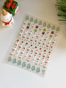 Vue détaillée d'autocollants 3D de Noël pour ongles avec motifs Père Noël et rennes