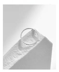 Macro shot of S925 sterling silver ring with diamond cut texture on stone pedestal