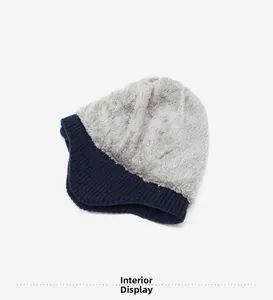Detailed view of winter knit hat featuring thick warm fleece lining in grey and navy blue
