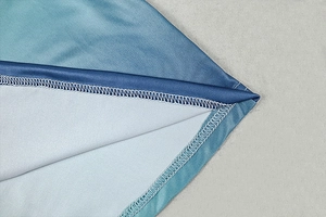 Close-up of overlock stitching detail on the blue gradient slim-fit maxi dress