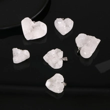 Detail view of six raw white quartz crystal heart-shaped pendants with metal loops