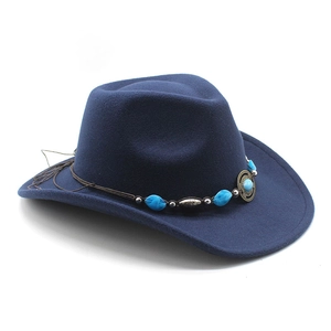Detail of navy felt cowboy hat featuring turquoise beads and ethnic metal buckle strap