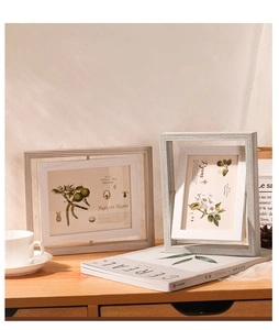 Close-up of double-sided rotating wooden photo frames in a cozy Nordic home setting